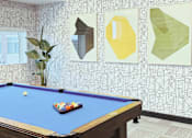 Thumbnail 11 of 37 - A pool table with a blue cloth and a white ball on it.
