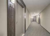 Thumbnail 3 of 19 - a hallway with a wooden door and a number on the wall