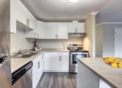 Thumbnail 6 of 23 - a kitchen with white cabinets and stainless steel appliances