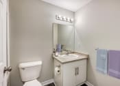 Thumbnail 14 of 23 - a bathroom with a toilet sink and mirror