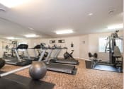 Thumbnail 2 of 23 - a gym with treadmills and other exercise equipment