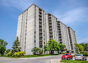 Thumbnail 1 of 10 - a picture of an apartment building with cars parked in front of it