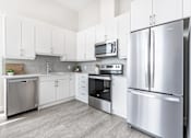 Thumbnail 13 of 37 - A modern kitchen with stainless steel appliances and white cabinets.