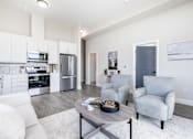Thumbnail 15 of 37 - A modern kitchen with white cabinets and stainless steel appliances.