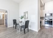 Thumbnail 22 of 37 - A kitchen with a dining table and chairs.
