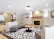 Thumbnail 7 of 15 - A modern living room with a fireplace and grey couches  at Platts Crossing, London, ON, N6H 4P4