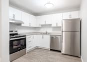 Thumbnail 6 of 10 - A modern kitchen with stainless steel appliances and white cabinets.