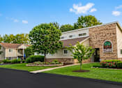 Thumbnail 5 of 11 - A building with a sign that says "Hill Terrace Apartments" is shown.