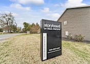 Thumbnail 1 of 67 - a sign in the grass in front of a building