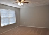 Thumbnail 36 of 51 - A room with a ceiling fan and a window with blinds.