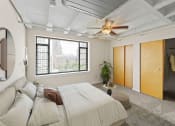 Thumbnail 17 of 43 - a bedroom with a bed and a ceiling fan