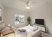 Thumbnail 40 of 67 - a bedroom with a large bed and a ceiling fan