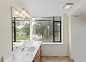 Thumbnail 8 of 43 - a bathroom with a sink and a large window