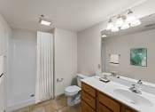 Thumbnail 31 of 43 - a bathroom with a large mirror and a sink and a toilet