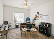 Thumbnail 46 of 67 - an office with a desk and chairs and a large window