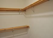 Thumbnail 49 of 51 - A wall with two shelves on it.