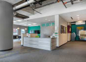Thumbnail 18 of 42 - a reception area with a desk and a sign on the wall