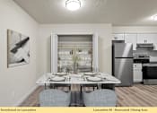 Thumbnail 16 of 24 - A dining area with a table set for two and a painting on the wall.