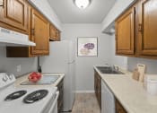 Thumbnail 31 of 48 - a kitchen with wooden cabinets and white appliances
