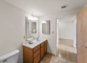 Thumbnail 29 of 43 - a bathroom with a toilet and a sink and a mirror