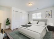 Thumbnail 33 of 43 - a bedroom with a white bed and a large white door