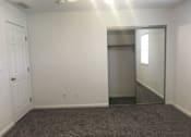 Thumbnail 23 of 51 - A room with a white door and a grey carpet.