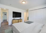 Thumbnail 38 of 43 - a bedroom with a large bed and a flat screen tv