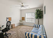 Thumbnail 41 of 67 - a living room with a couch and a ceiling fan