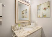 Thumbnail 8 of 43 - a bathroom with a sink and a mirror