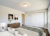 Thumbnail 16 of 43 - a bedroom with a bed and a dresser