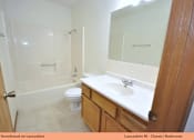Thumbnail 11 of 24 - A bathroom with a toilet, sink and shower.