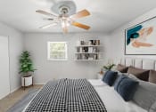 Thumbnail 12 of 48 - a bedroom with a large bed and a ceiling fan