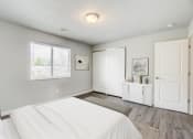 Thumbnail 6 of 43 - a bedroom with a white bed and a white dresser
