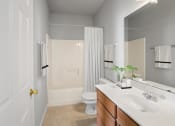 Thumbnail 48 of 48 - a bathroom with a white toilet next to a white sink with a mirror above it