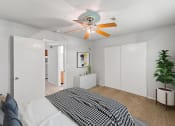 Thumbnail 18 of 48 - a bedroom with a ceiling fan and white walls