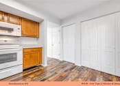 Thumbnail 25 of 35 - A kitchen with wooden cabinets and white appliances.