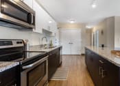 Thumbnail 39 of 42 - a kitchen with granite counter tops and stainless steel appliances