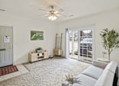 Thumbnail 51 of 67 - a living room with a white couch and a ceiling fan