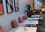 Thumbnail 6 of 10 - a row of pink pillows on a white wall in front of a white toilet