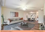 Thumbnail 6 of 31 - a living room with a couch and a table