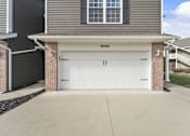 Thumbnail 30 of 67 - a white garage door on the side of a house