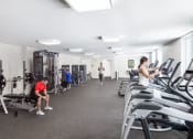 Thumbnail 17 of 42 - a group of people working out in a gym