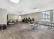 Thumbnail 14 of 42 - a large room with tables and chairs and a large window
