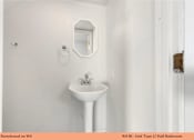 Thumbnail 34 of 35 - A white sink in a small bathroom.