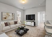 Thumbnail 41 of 48 - a living room with a couch coffee table and a tv on the wall