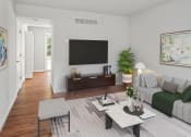 Thumbnail 25 of 48 - a living room with a couch coffee table and a tv on the wall