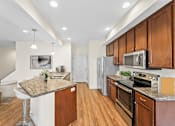 Thumbnail 57 of 67 - a kitchen with wooden cabinets and stainless steel appliances