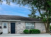 Thumbnail 3 of 14 - A house with a black door and a white door.