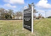 Thumbnail 3 of 67 - a sign in the middle of a grass field