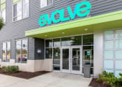 Thumbnail 11 of 42 - the exterior of an evo store with a green sign above the door